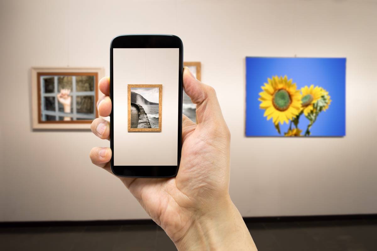 phone pointing at artworks in an exhibition